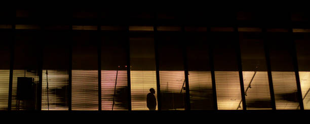 istock Silhouette of a man at the windows at night 1472141462
