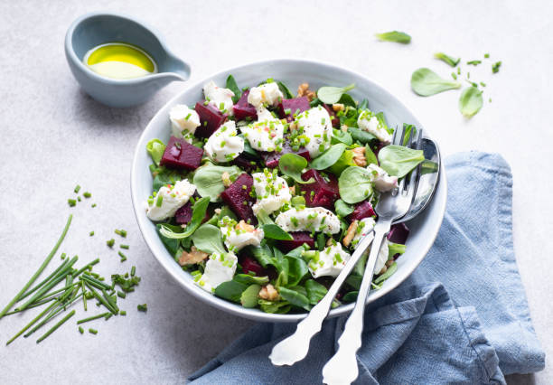 istock Light, summer salad with goat cheese, beetroot pieces, walnuts, olive oil and herbs. Mediterranean salads, typical dishes of Spain, France, Turkey and Italy, front view 1472141628