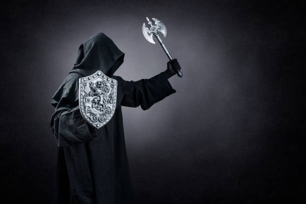 istock Dark knight with axe and shield over dark misty background 1472142353
