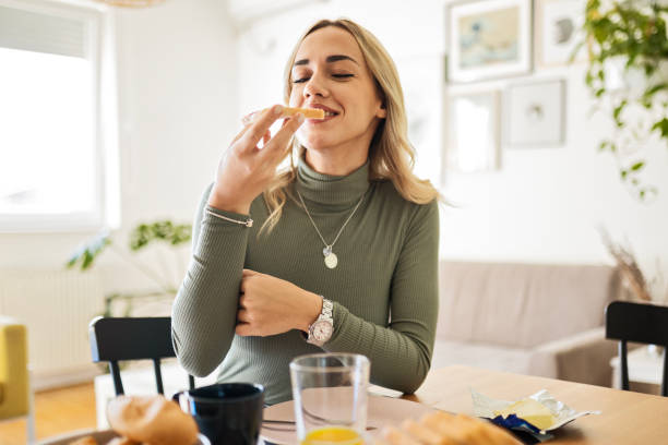 istock Young woman eating 1472145378
