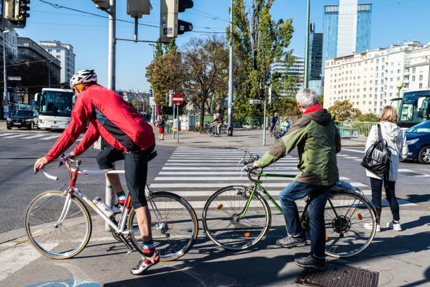 Vienna, Austria - October 18, 2022: People on bicycles on the street standing at a traffic light in Vienna, Austria