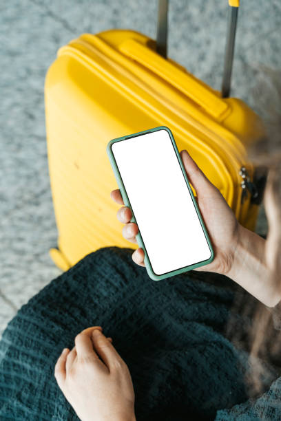 istock Using phone in travelling. Blank screen smartphone at the airport before the flight. Application for travel, banking, concept. 1472149622
