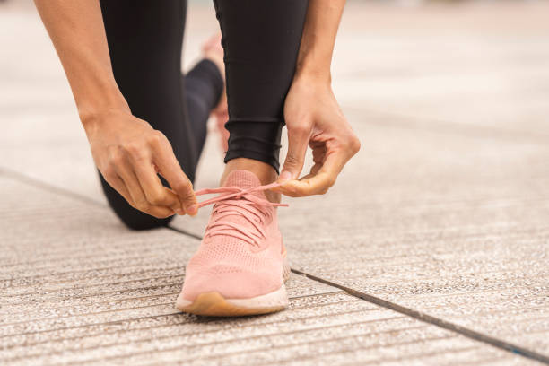 istock Ready to Run: A Black Female Athlete Ties Her Sneakers 1472150416