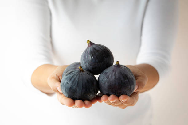 istock Woman Showing Fresh Figs 1472150936