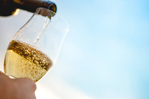 Pouring champagne into a glass stock photo