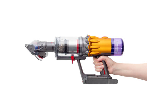 istock Woman's hand holds Modern cordless vacuum cleaner isolated on white background. 1472153492