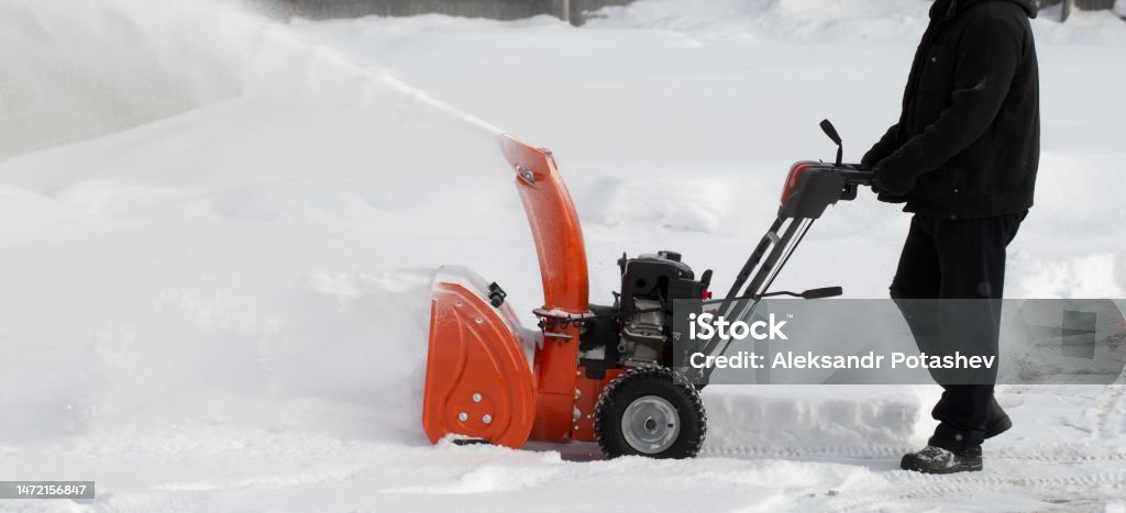 A portable snow blower powered by gasoline. A portable snow blower powered by gasoline. Snow removal in winter. Snowblower Stock Photo
