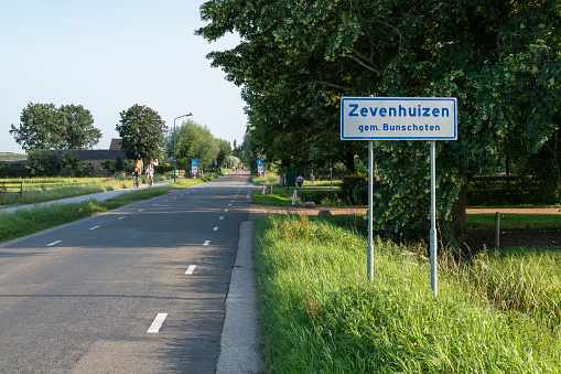 Bunschoten, Netherlands, July 22, 2021; Countryside road through the rural area of ​​the hamlet of Zevenhuizen in the municipality of Bunschoten.