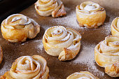 homemade puff pastry buns with apples, powdered sugar