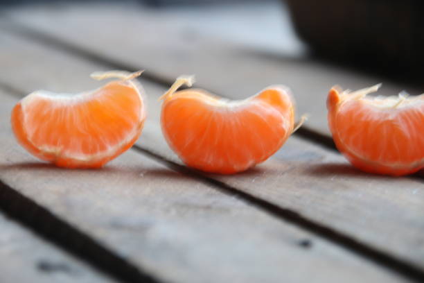 istock Slice of tangerine on vintage table. 1472159051