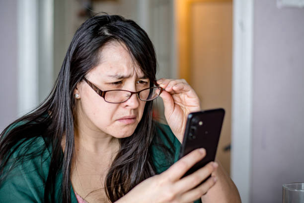 istock The need for clarity: A woman adjusts her glasses to confront cybersecurity risks 1472159655