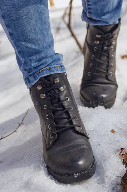istock Woman winter boot on snow. 1472160176