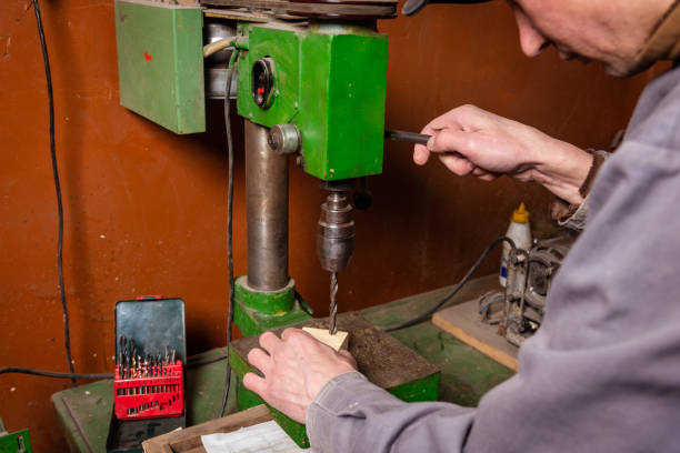 istock A carpenter works in a workshop with a saw, planer and various tools 1472161661