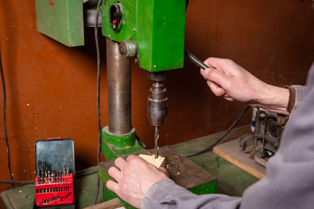 istock A carpenter works in a workshop with a saw, planer and various tools 1472161662
