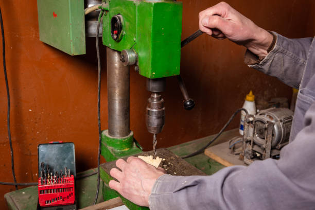 istock A carpenter works in a workshop with a saw, planer and various tools 1472161668