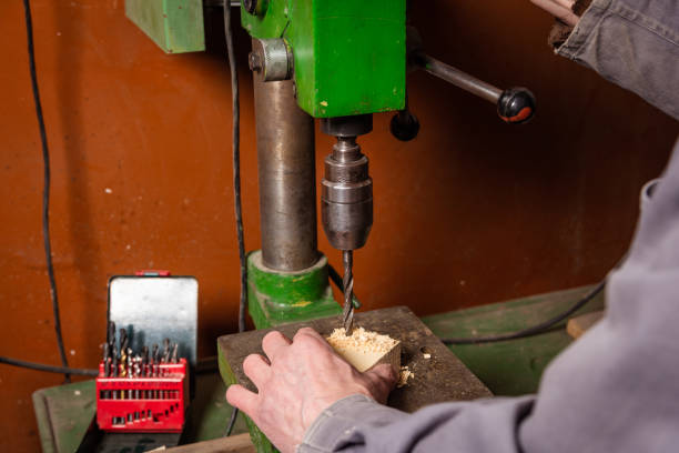istock A carpenter works in a workshop with a saw, planer and various tools 1472161695