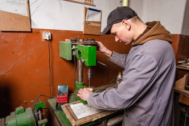 istock A carpenter works in a workshop with a saw, planer and various tools 1472161696