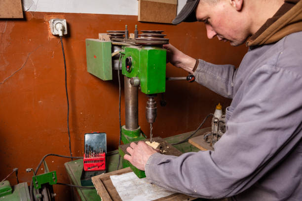 istock A carpenter works in a workshop with a saw, planer and various tools 1472161701