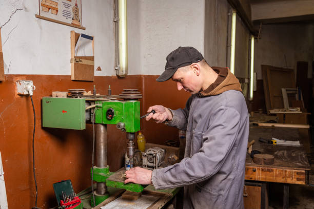 istock A carpenter works in a workshop with a saw, planer and various tools 1472161714