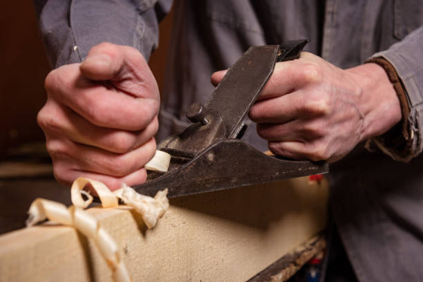 istock A carpenter works in a workshop with a saw, planer and various tools 1472162261