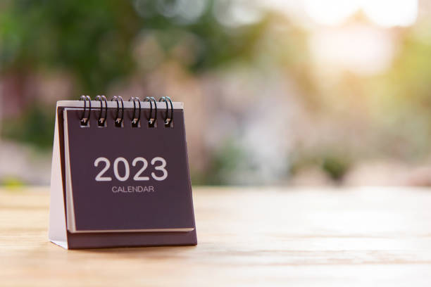 istock 2023 Desk calendar on wooden table. Copy space 1472162338