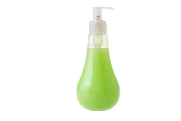 Green liquid soap in  transparent bottle with dispenser pump isolated on white background.