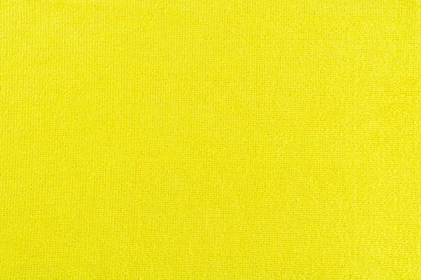 istock Yellow microfiber cloth textured background. Rag for cleaning and polishing various surfaces. 1472162982