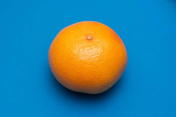 istock Orange Grapefruit isolated on cyan blue background 1472167689