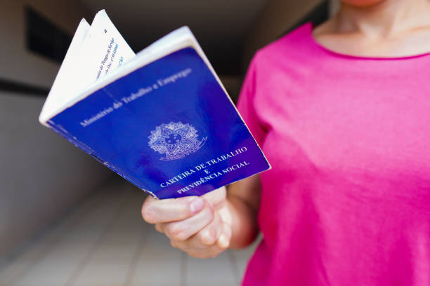 istock A safe woman Work and Social Security Card (Carteira de Trabalho) seen displayed. It is the document that guarantees access to the rights of the Brazilian worker. 1472169063