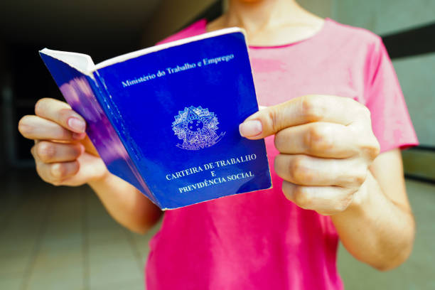 istock A safe woman Work and Social Security Card (Carteira de Trabalho) seen displayed. It is the document that guarantees access to the rights of the Brazilian worker. 1472169066