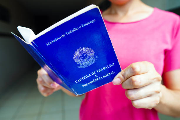 istock A safe woman Work and Social Security Card (Carteira de Trabalho) seen displayed. It is the document that guarantees access to the rights of the Brazilian worker. 1472169094