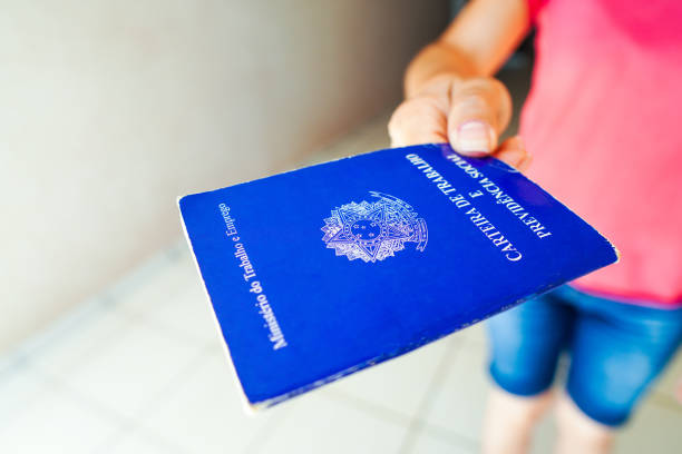 istock A safe woman Work and Social Security Card (Carteira de Trabalho) seen displayed. It is the document that guarantees access to the rights of the Brazilian worker. 1472169099