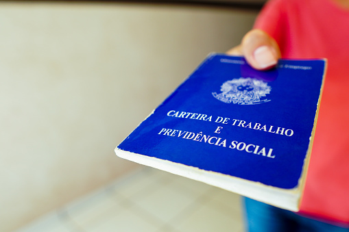 A safe woman Work and Social Security Card (Carteira de Trabalho) seen displayed. It is the document that guarantees access to the rights of the Brazilian worker