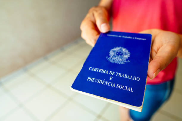 istock A safe woman Work and Social Security Card (Carteira de Trabalho) seen displayed. It is the document that guarantees access to the rights of the Brazilian worker. 1472169147