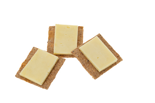 Cheese slices on cracker biscuits - white background