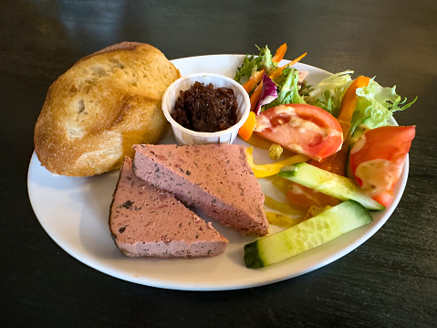 Pate with a fresh bread bun and a side salad