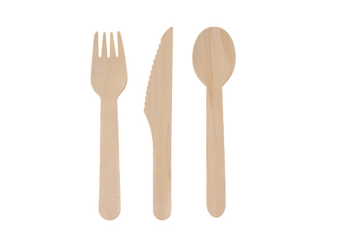 A wooden table knife, fork and spoon - white background