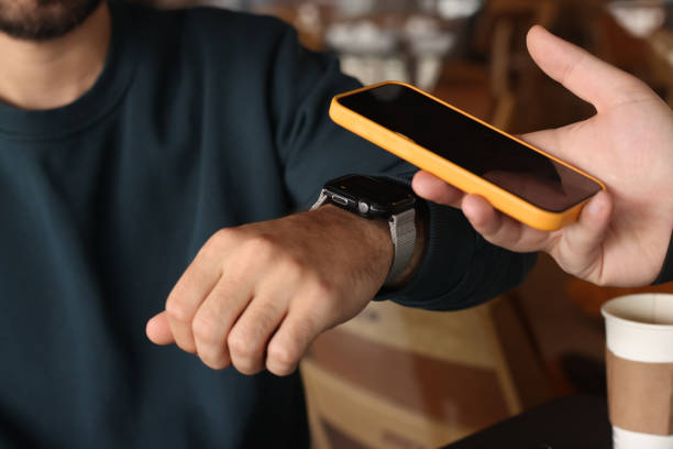 Man making NFC payment with his smart watch stock photo