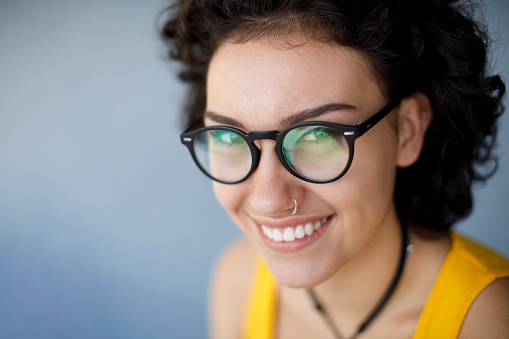 Portrait of young smiling woman wearing eyeglasses