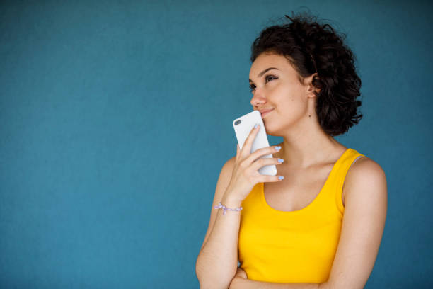 Young woman making a decision isolated on blue background