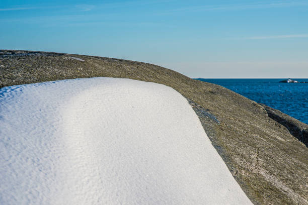 Melting snow on sunny cliffs by the sea.