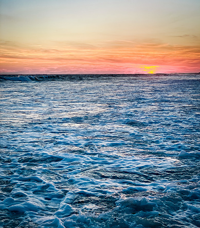 Textured ocean horizon and sunset looks like a painting.