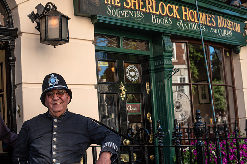 London, England, UK.  9th July 2022.\nA traditional British policeman poses for photographs outside the Sherlock Homes house and museum, 221b Baker Street, London, Great Britain