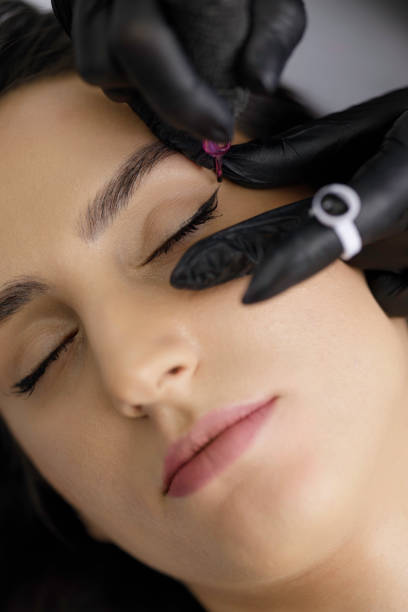 istock Permanent eye make-up application by a make-up artist in a beauty salon 1472174117