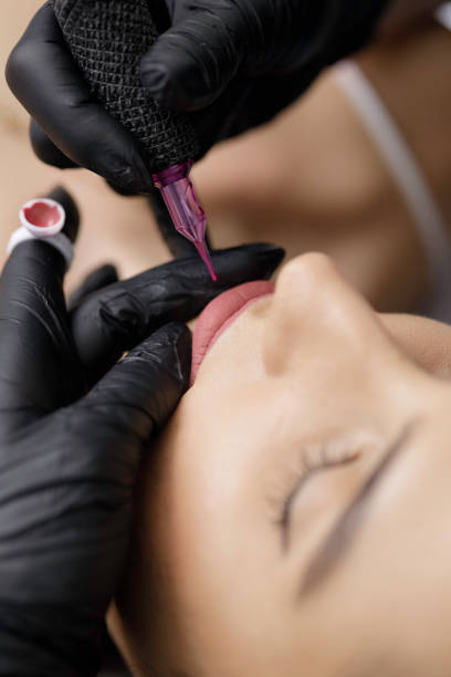 istock Permanent lip make-up application by a make-up artist in a beauty salon 1472174184