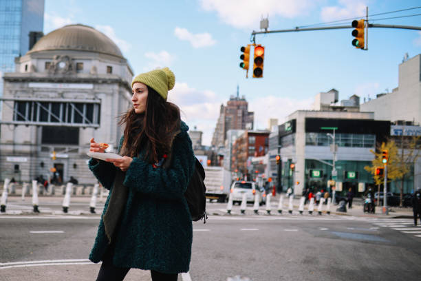 istock commuter having a pizza slice on the go in NYC 1472178798