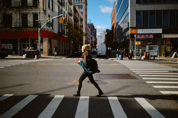 commuter having a pizza slice on the go in NYC stock photo