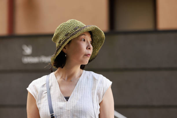 istock Japanese woman with hat outdoors looking to the side 1472183340