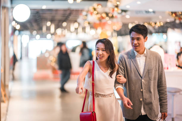 istock Romantic Young Couple Window Shopping At The Mall 1472187500