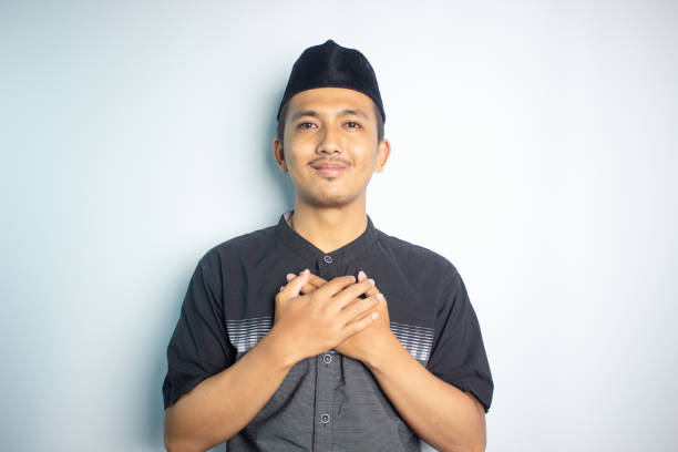 istock Smiling young Asian man wearing islamic shirt 1472189868